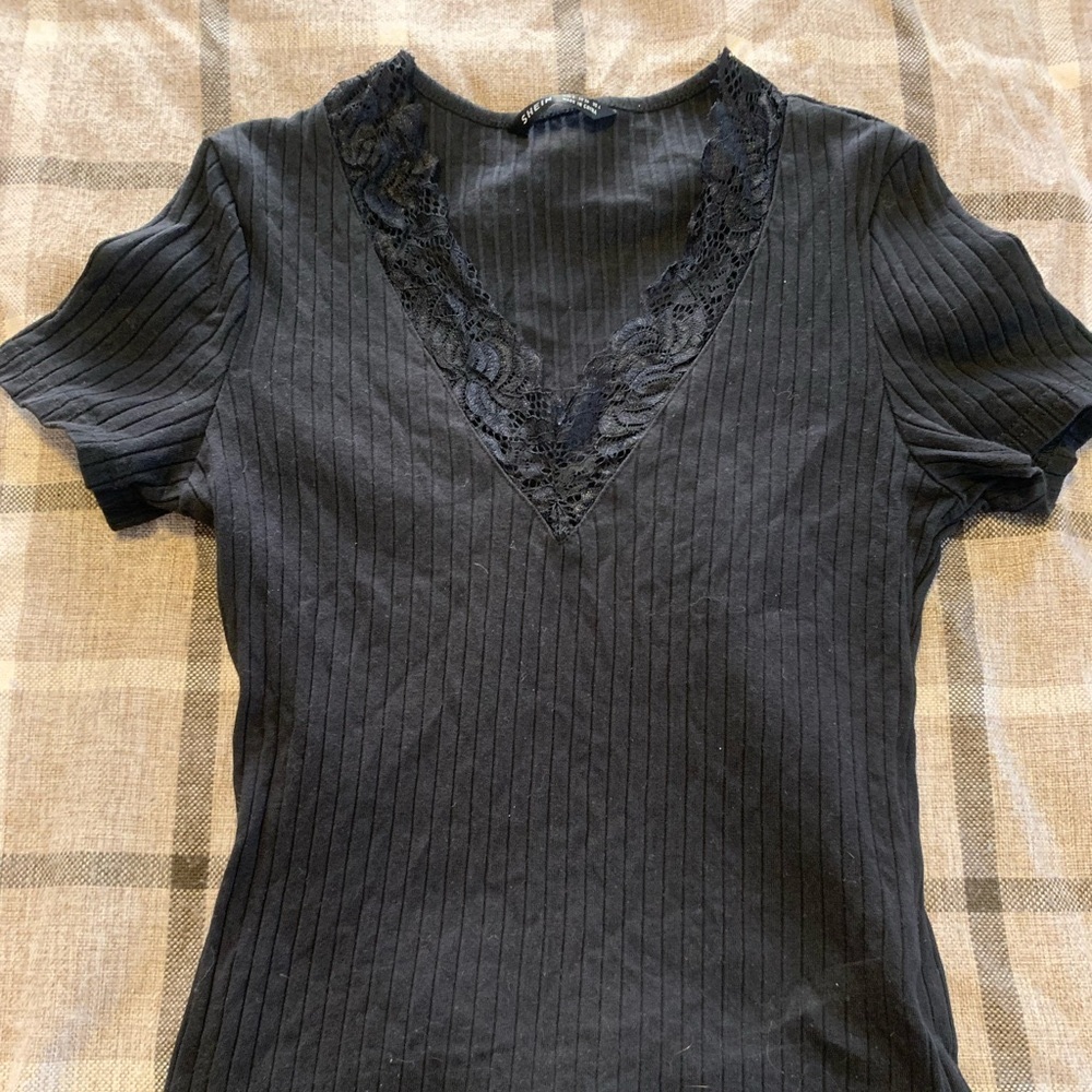 Size small. Black shirt sleeve shirt with a laced neck